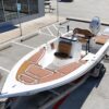 2023 Sportsman Open 212 Center Console boat with seating and a Suzuki outboard motor, showcasing the deck layout and helm area.