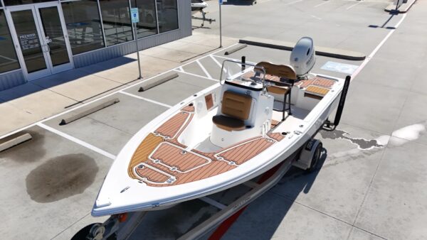 2023 Sportsman Open 212 Center Console boat with seating and a Suzuki outboard motor, showcasing the deck layout and helm area.